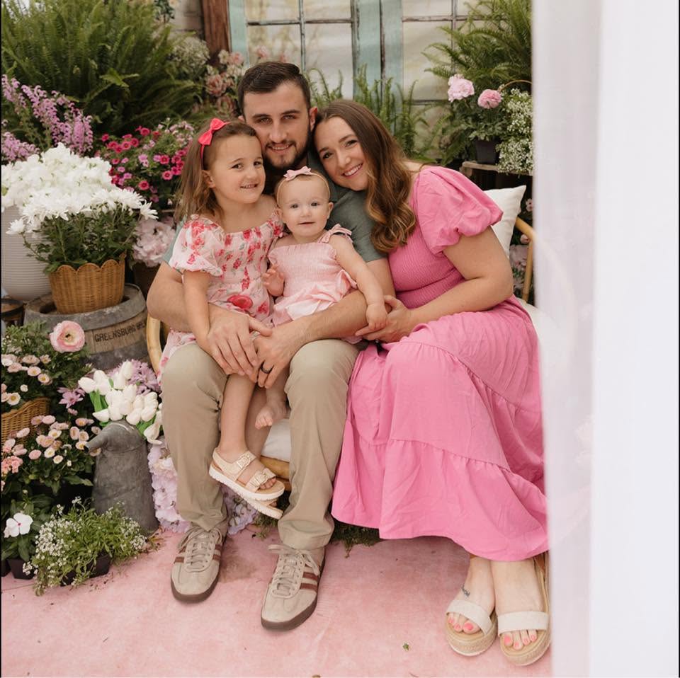 Jimmy, Leah, Layla, and Sadie Patterson together among spring flowers